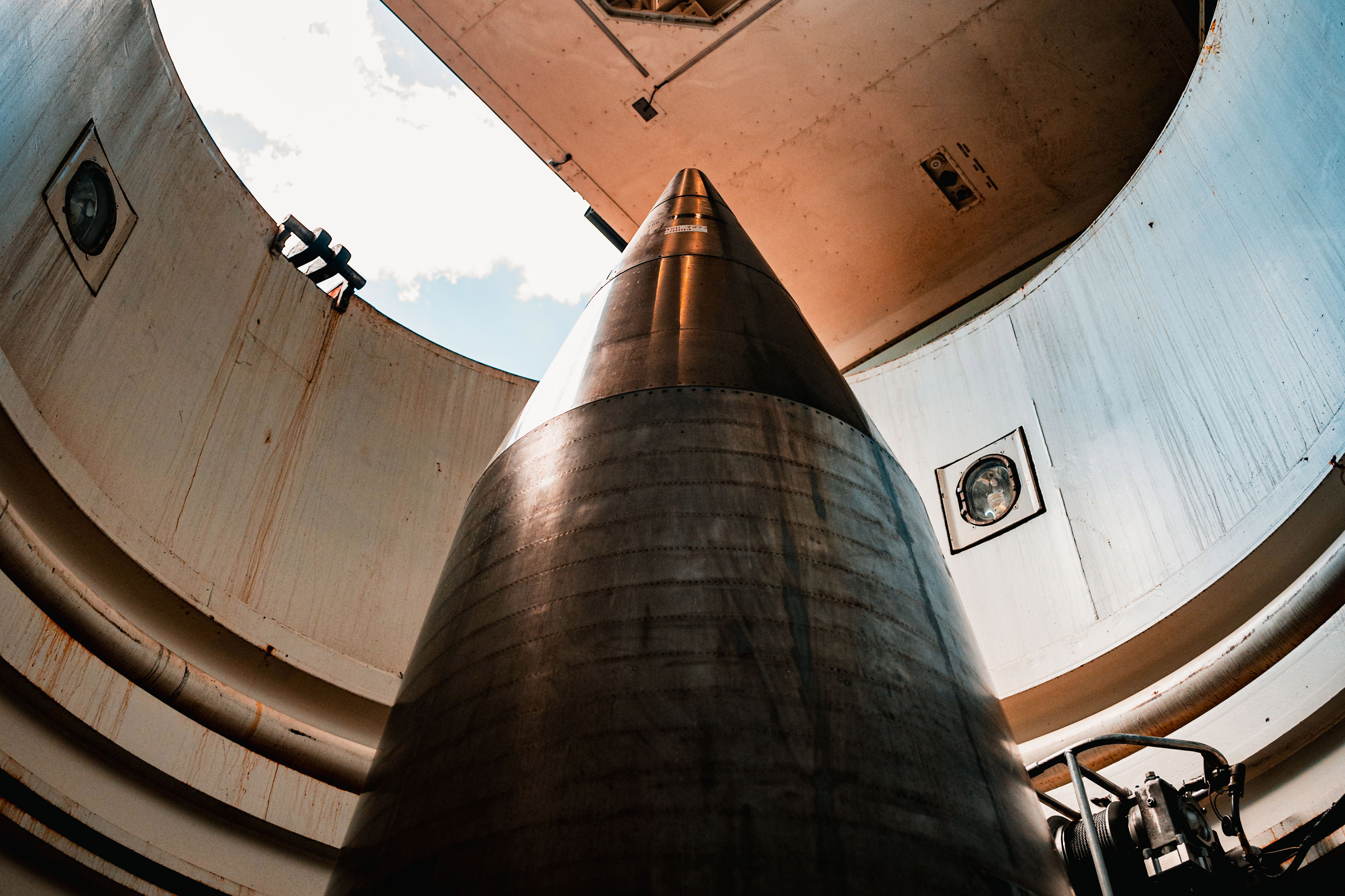 The tip of a missile is shown in a silo
